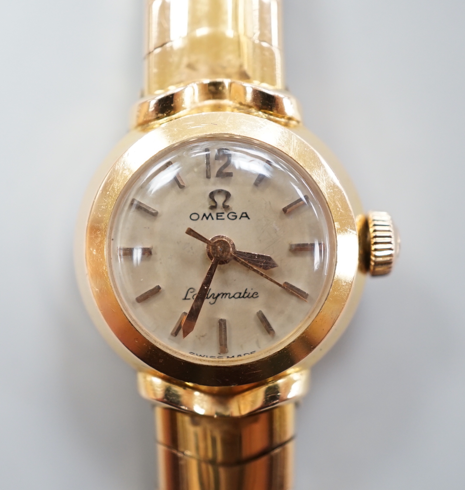 A lady's yellow metal, stamped 750, Omega Ladymatic wrist watch, on a 750 bracelet, length 17.cm, gross weight 38.9 grams.